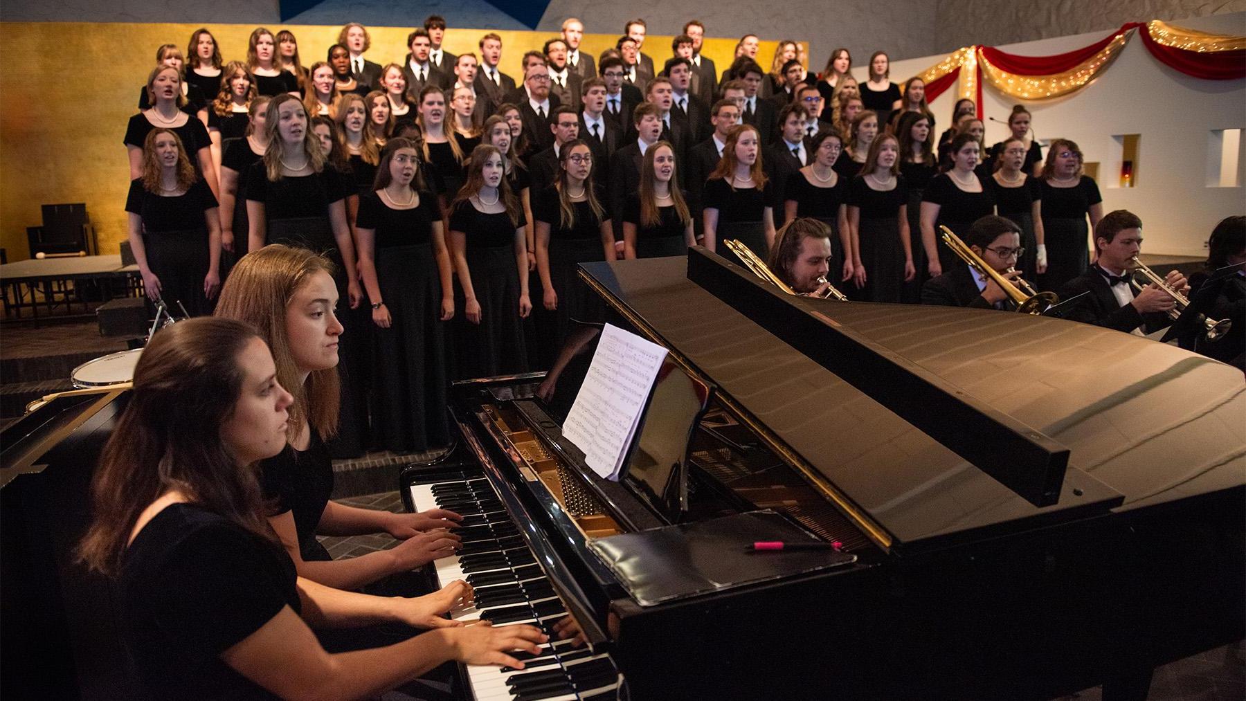 The Choir sining in Our Lady of Annunciation Chapel with the piano playing and brass instraments.